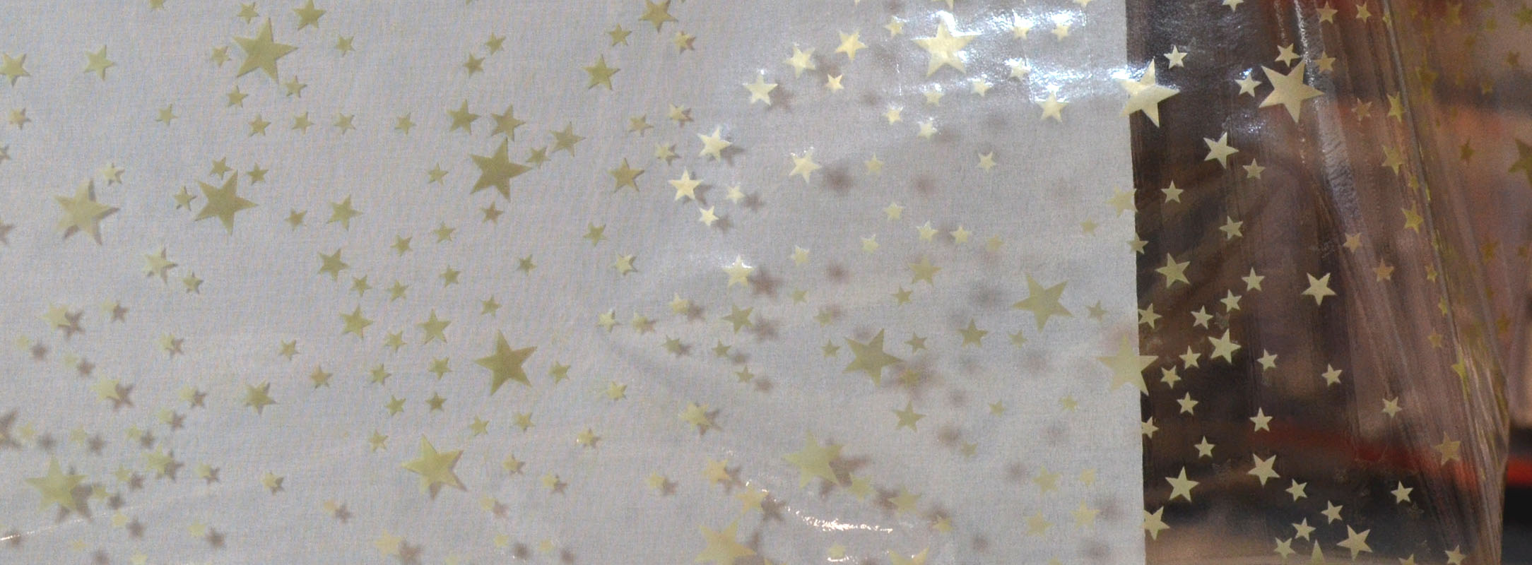 Glasklar-Tischfolie Sterne Gold von der Rolle 130 breit Meterware